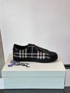 Burberry black lace-up sneakers with check panel detail and textured fringe