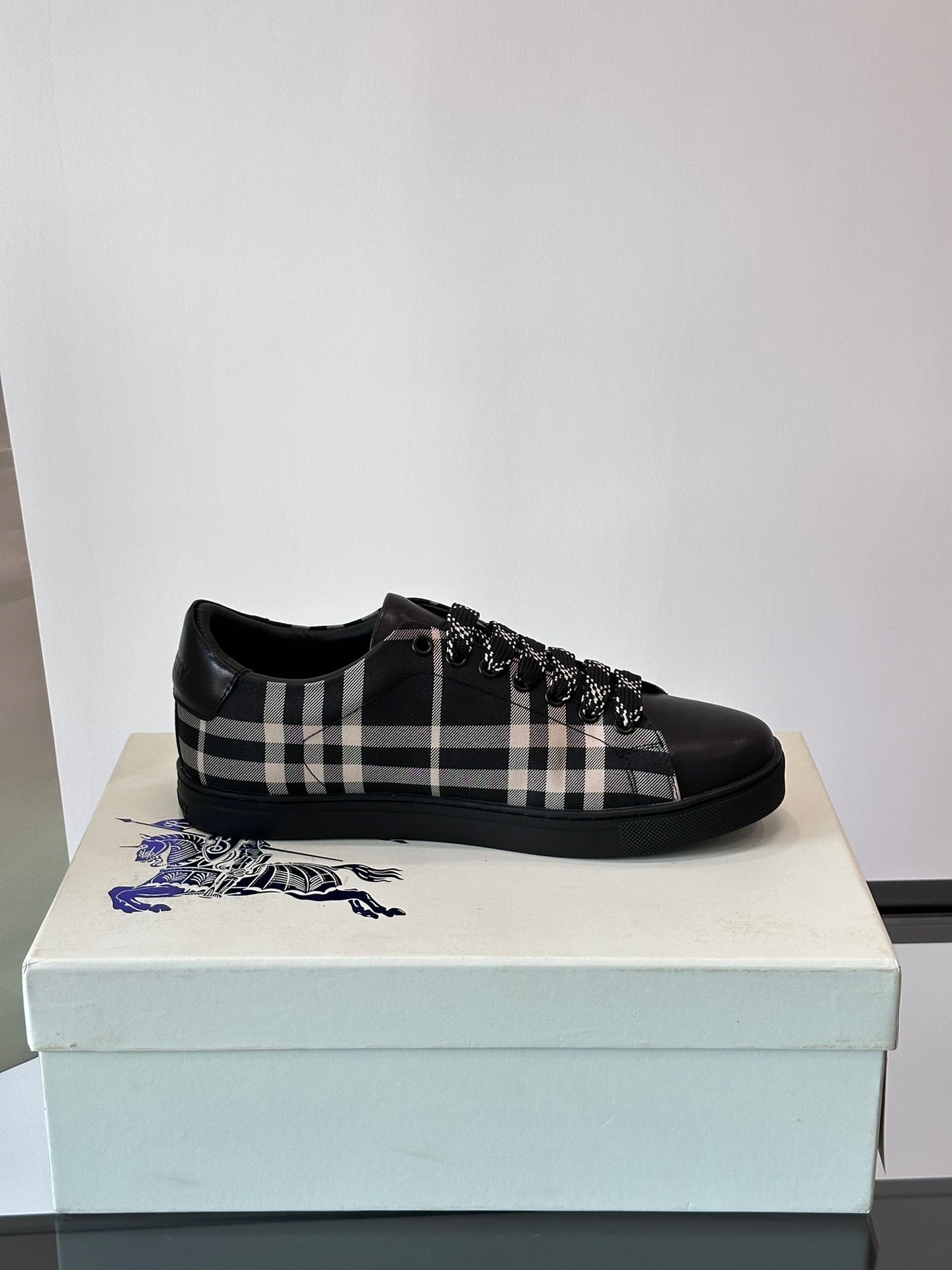 Burberry black lace-up sneakers with check panel detail and textured fringe