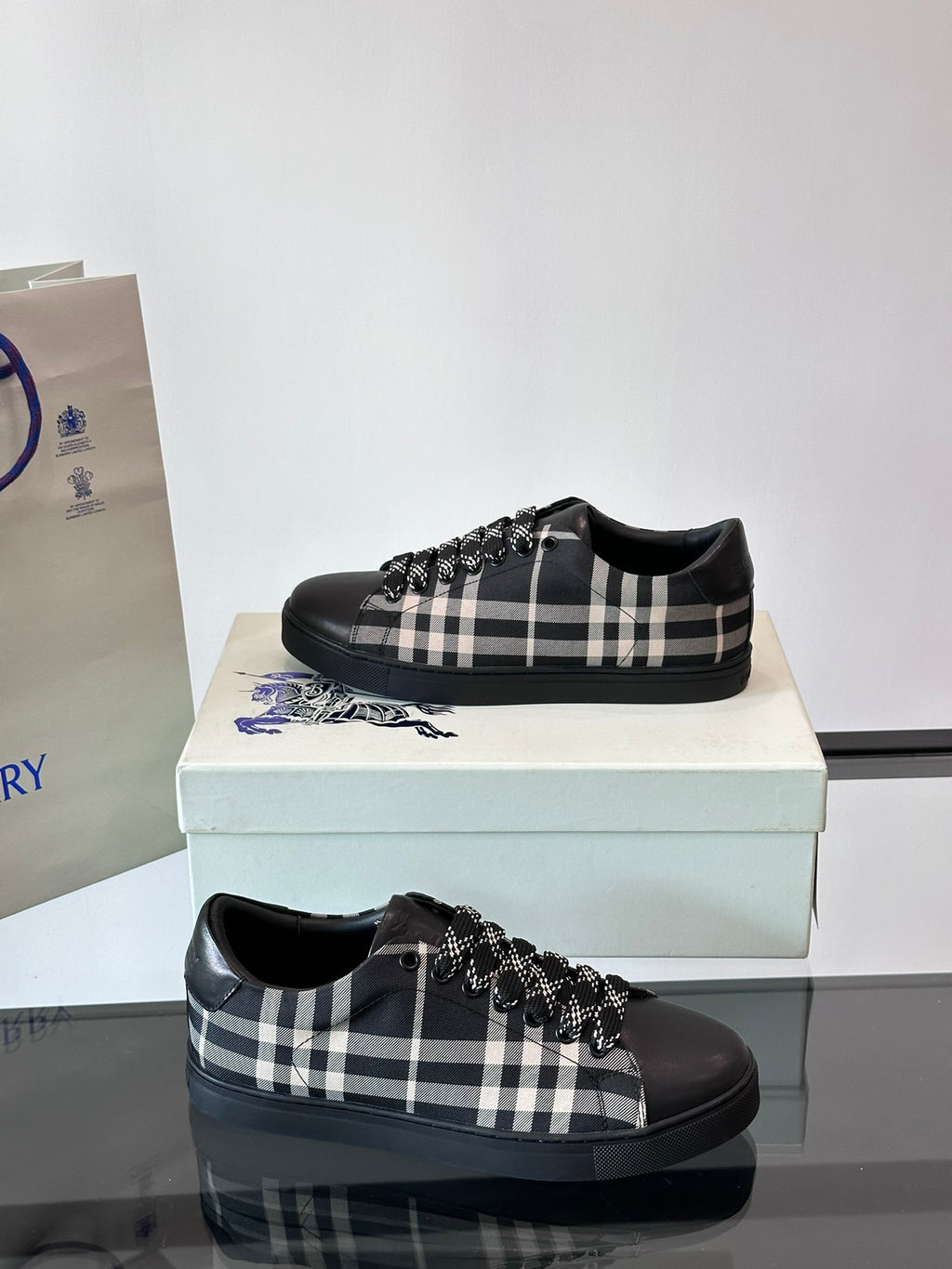 Burberry black lace-up sneakers with check pattern and fringe trim