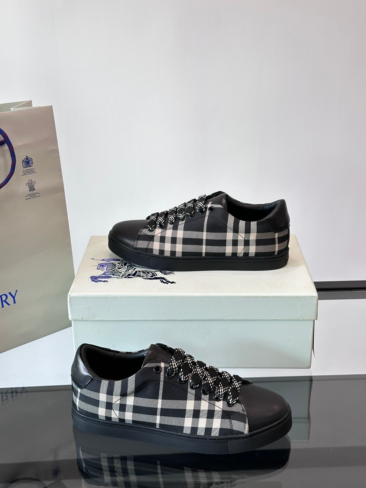 Burberry black lace-up sneakers with check pattern and fringe trim