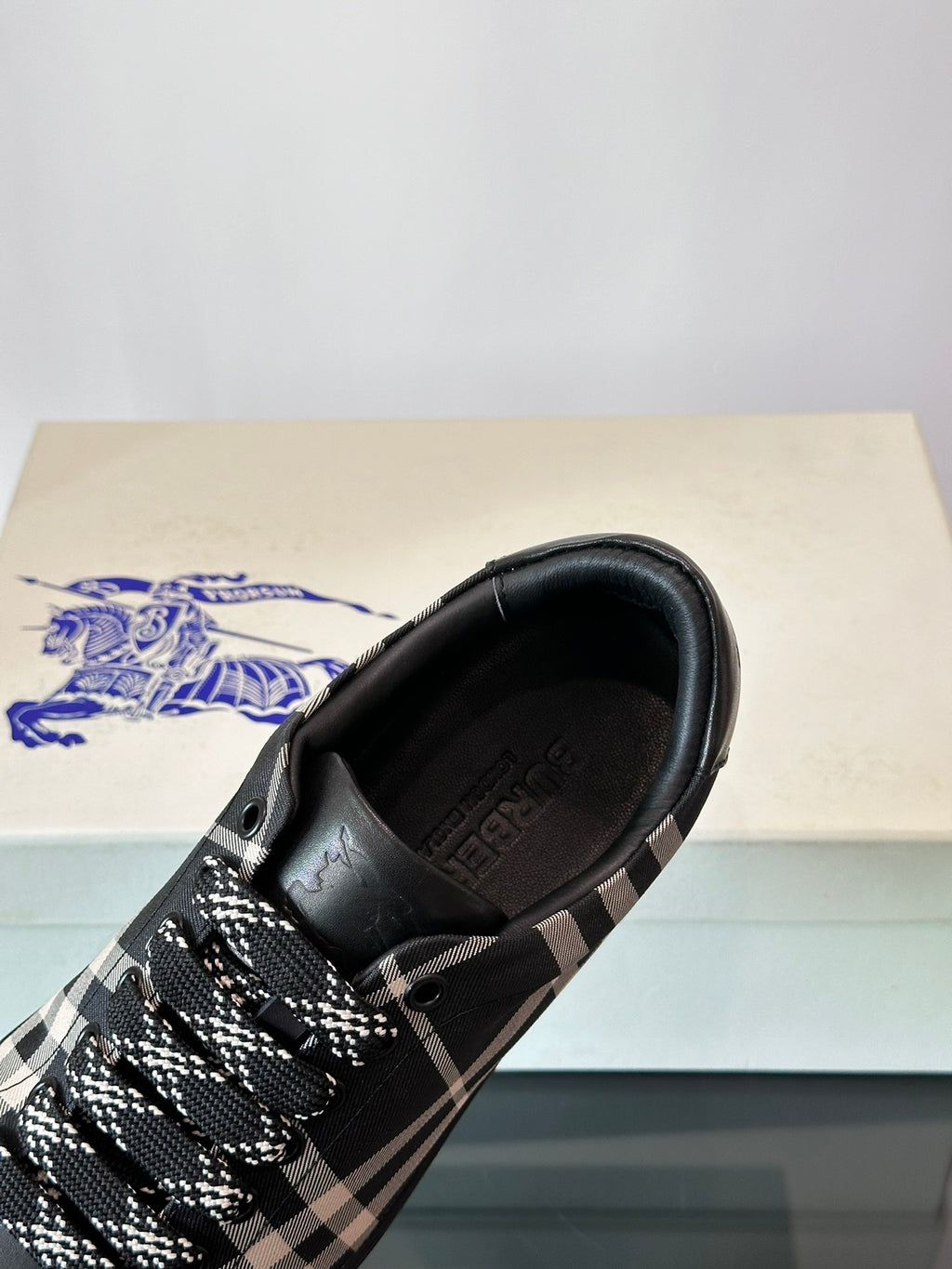 Burberry sneaker heel and side, black leather with check-pattern laces