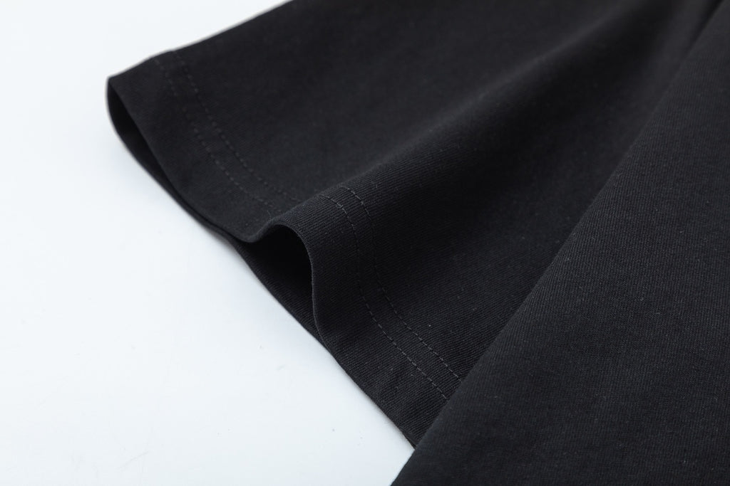 Black Gucci T-shirt hem and side seam close-up