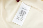 Cream short with Gucci care and size label