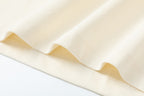 Cream T-shirt hem and fabric drape close-up