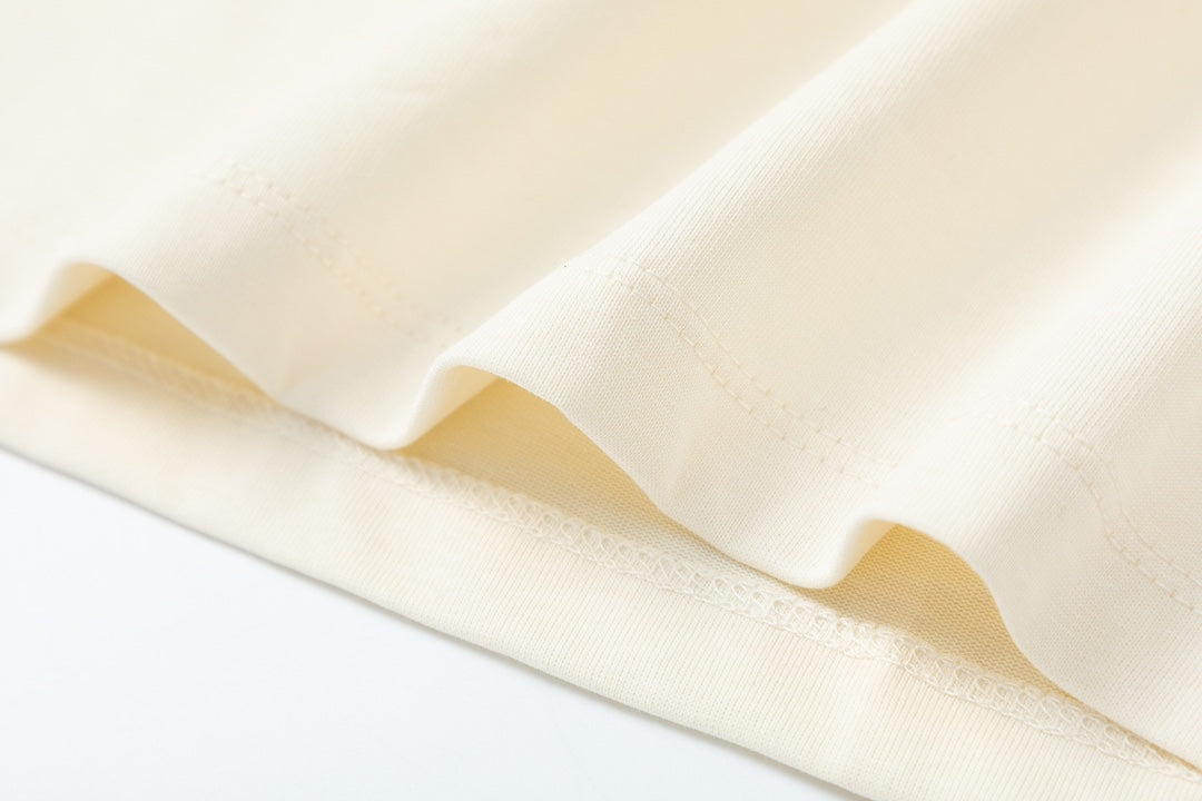 Cream T-shirt hem and fabric drape close-up