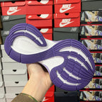 Purple and white Balenciaga sneaker outsole with textured tread and curved rubber