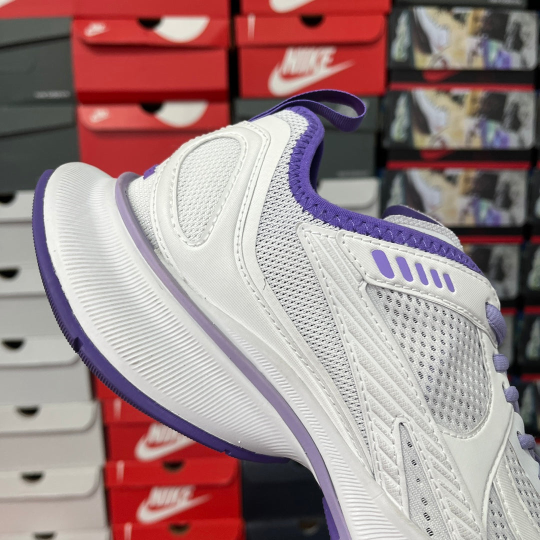 White Balenciaga sneaker with purple heel collar and lace-up front, side mesh panels