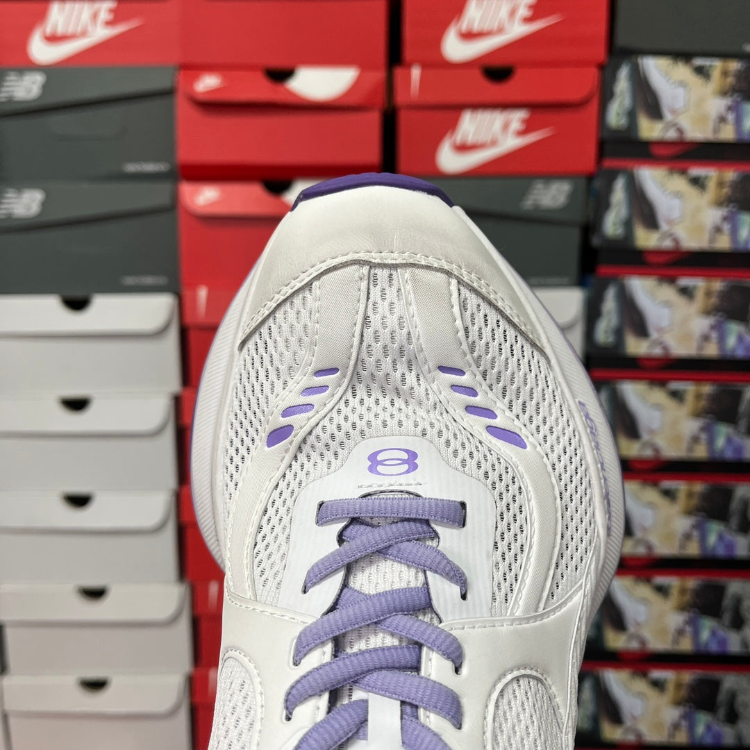 White Balenciaga sneaker toe view with purple laces, lace cage, and mesh panels
