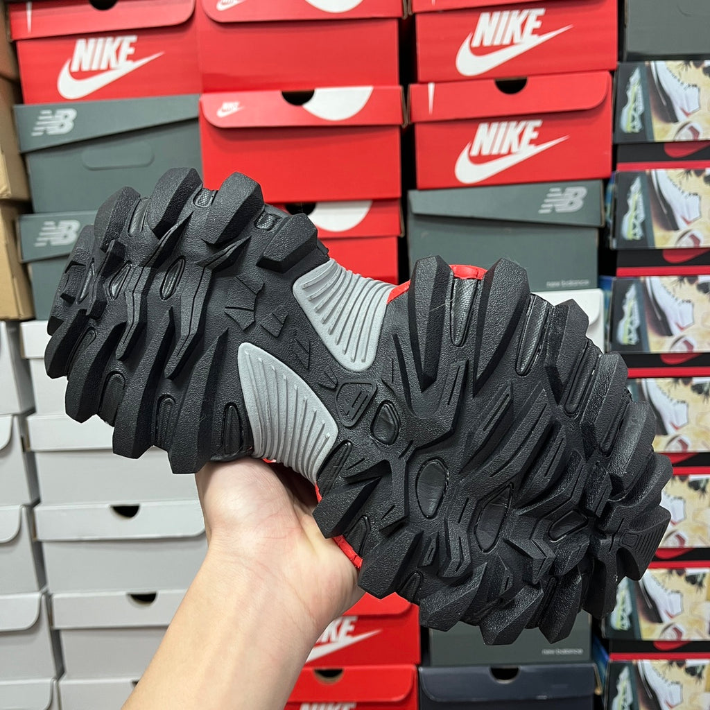 Black tread outsole with gray side panel, rugged traction pattern
