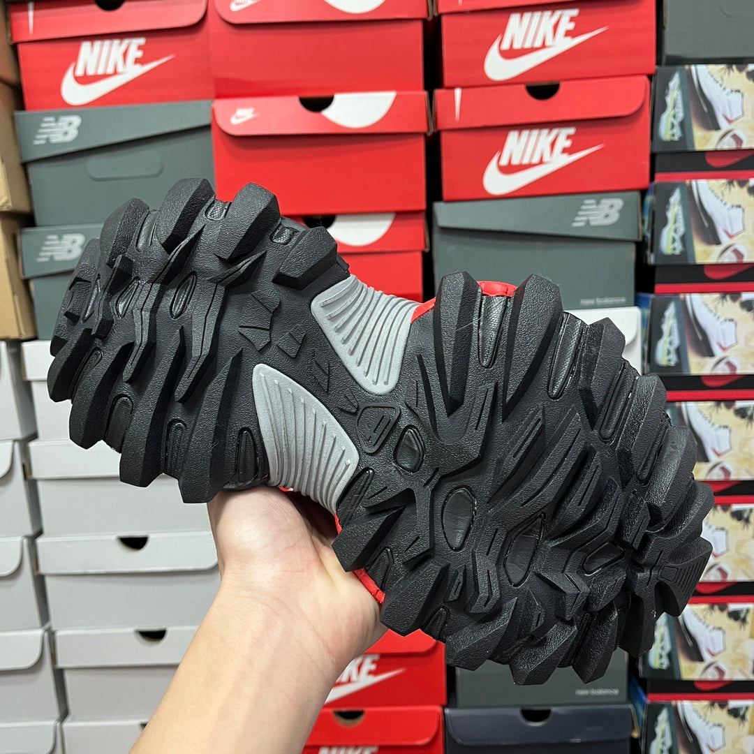 Black tread outsole with gray side panel, rugged traction pattern
