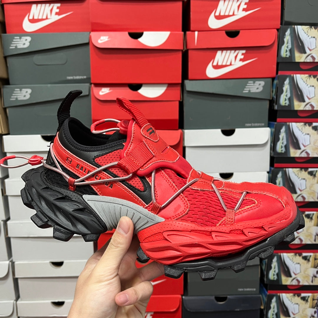 Red and black chunky sneaker with black laces and thick gray outsole