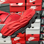Red textured sneaker upper with thick black tread sole, side angle
