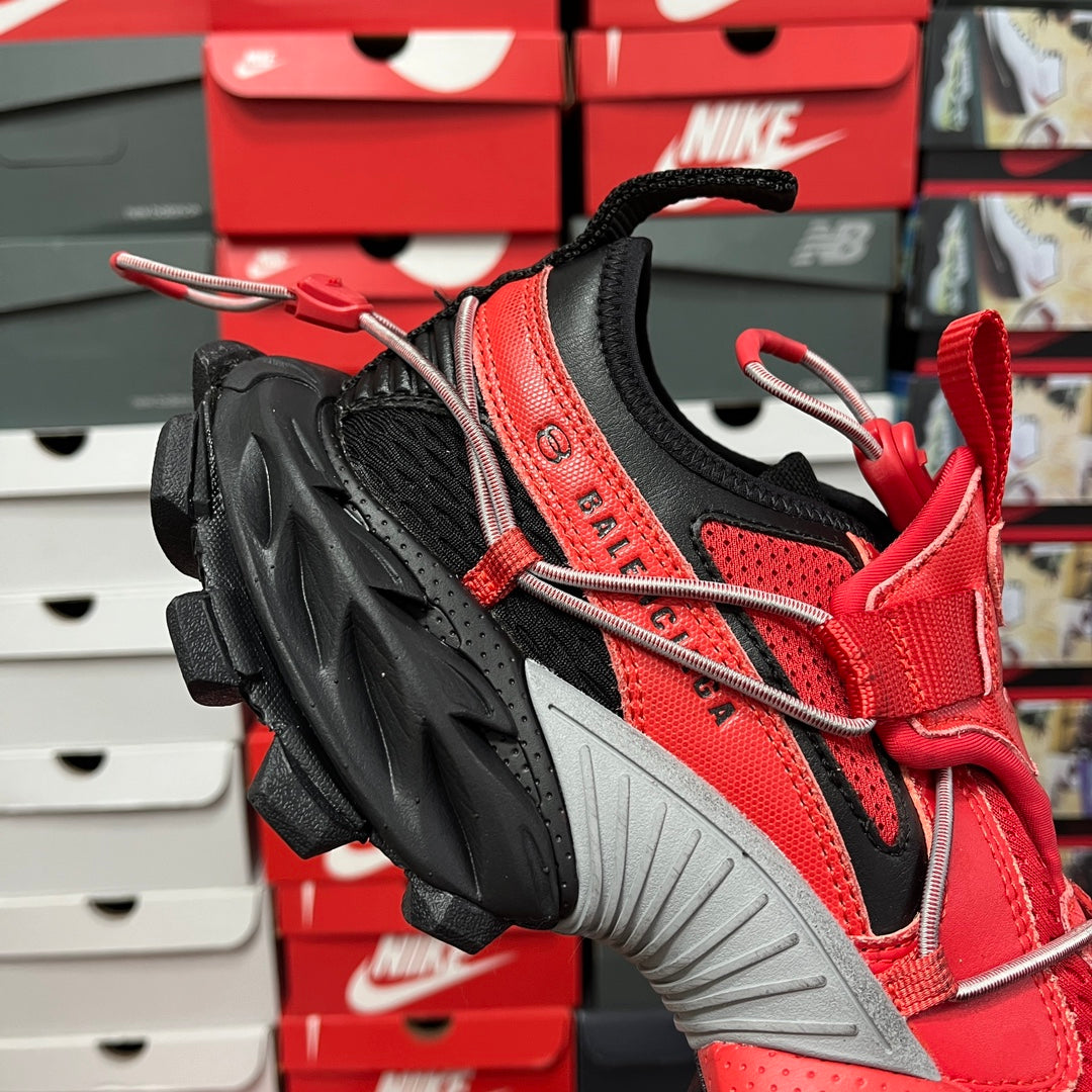 Red and black knit sneaker with lace-up cords and chunky black sole