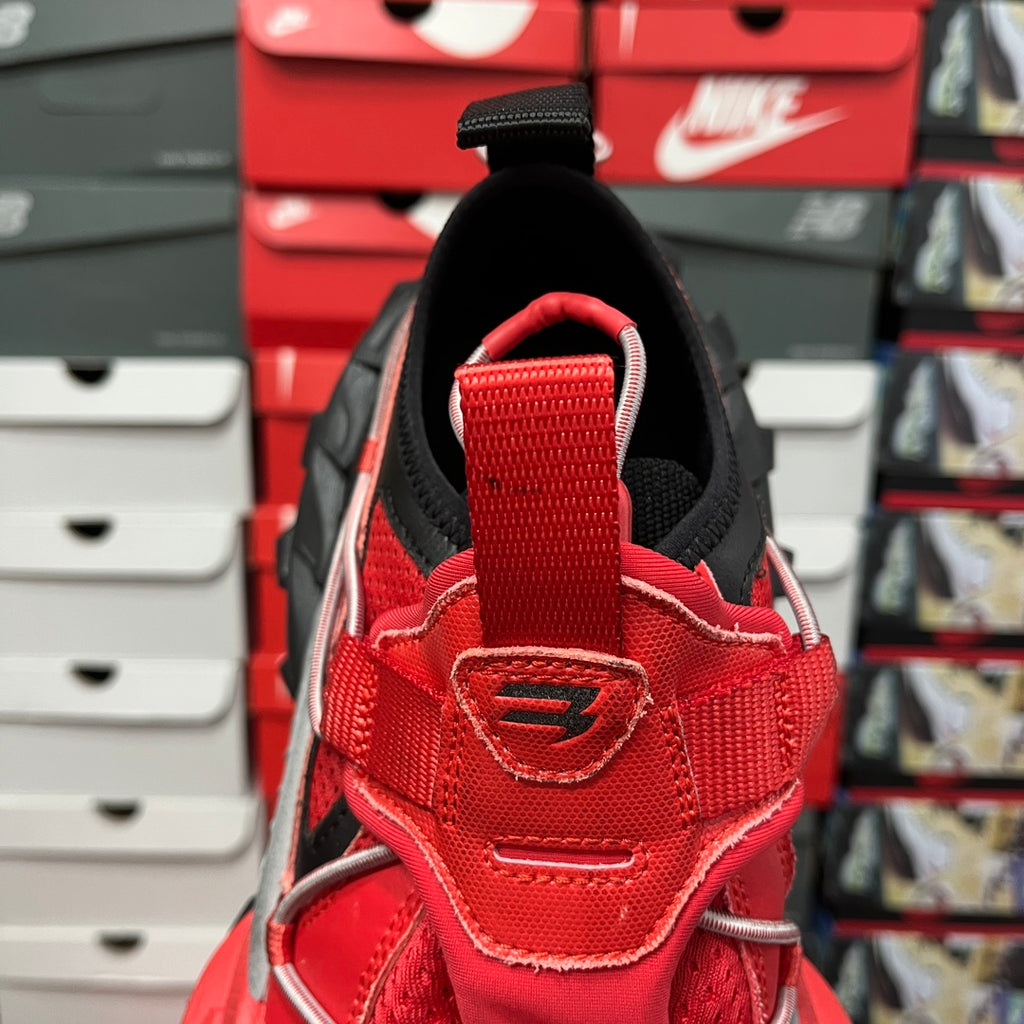 Red sneaker heel with black collar, stitched logo patch on back