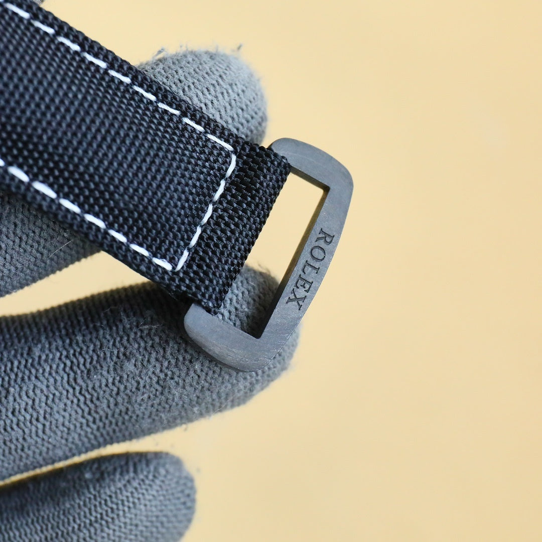 Rolex Daytona strap clasp with black fabric strap and metal buckle.