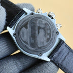 Rolex Daytona case back with round metal backplate and strap openings.