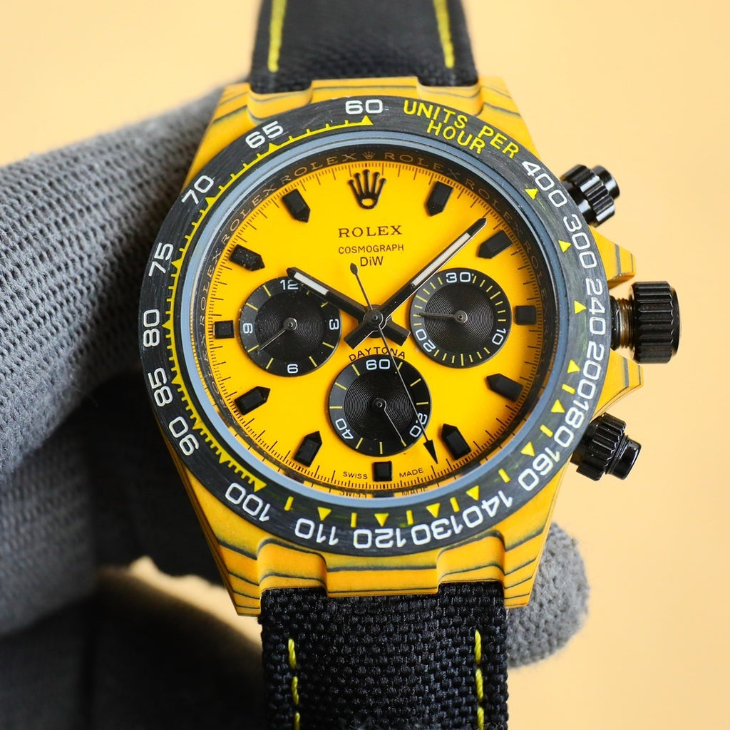 Rolex Daytona watch with yellow dial, black bezel, and black fabric strap.