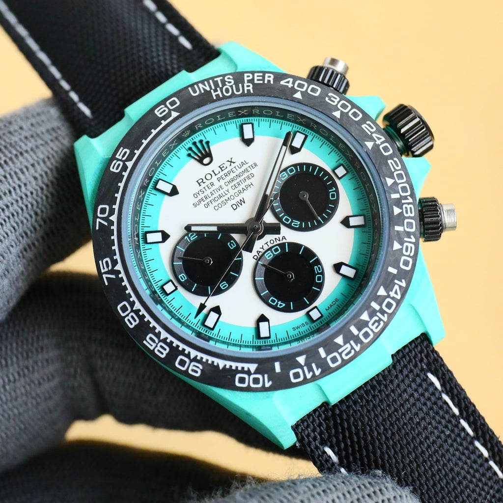 Rolex Daytona chronograph watch with teal dial, black subdials, and teal bezel insert.