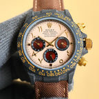 Rolex Daytona watch with champagne dial, brown fabric strap, and gold-tone pushers.