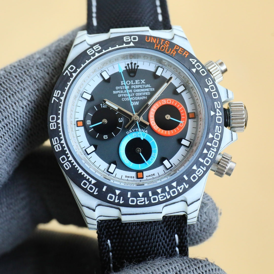 Rolex chronograph watch with white dial, orange and blue accents, stainless case, black strap