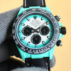 Rolex chronograph watch with teal dial, teal bezel, stainless case, black fabric strap