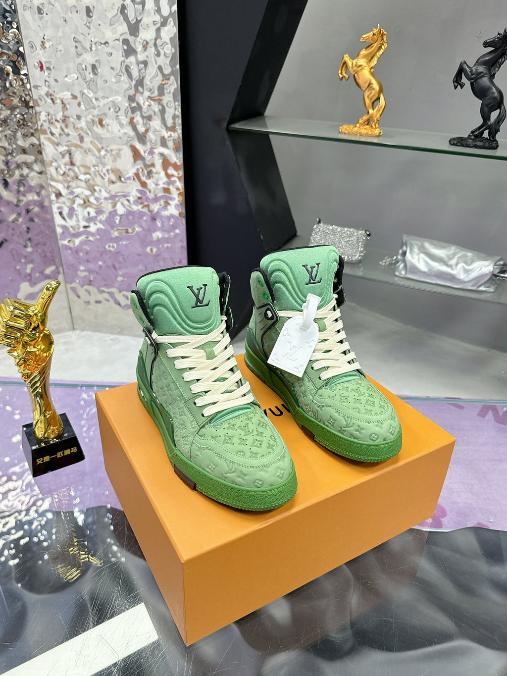 Green high-top Louis Vuitton sneakers with white laces and monogram detailing