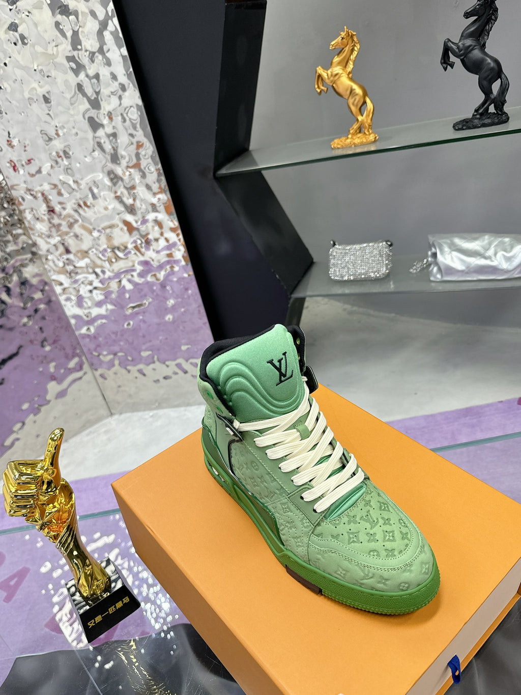 Green Louis Vuitton high-top sneaker with white laces and textured monogram upper
