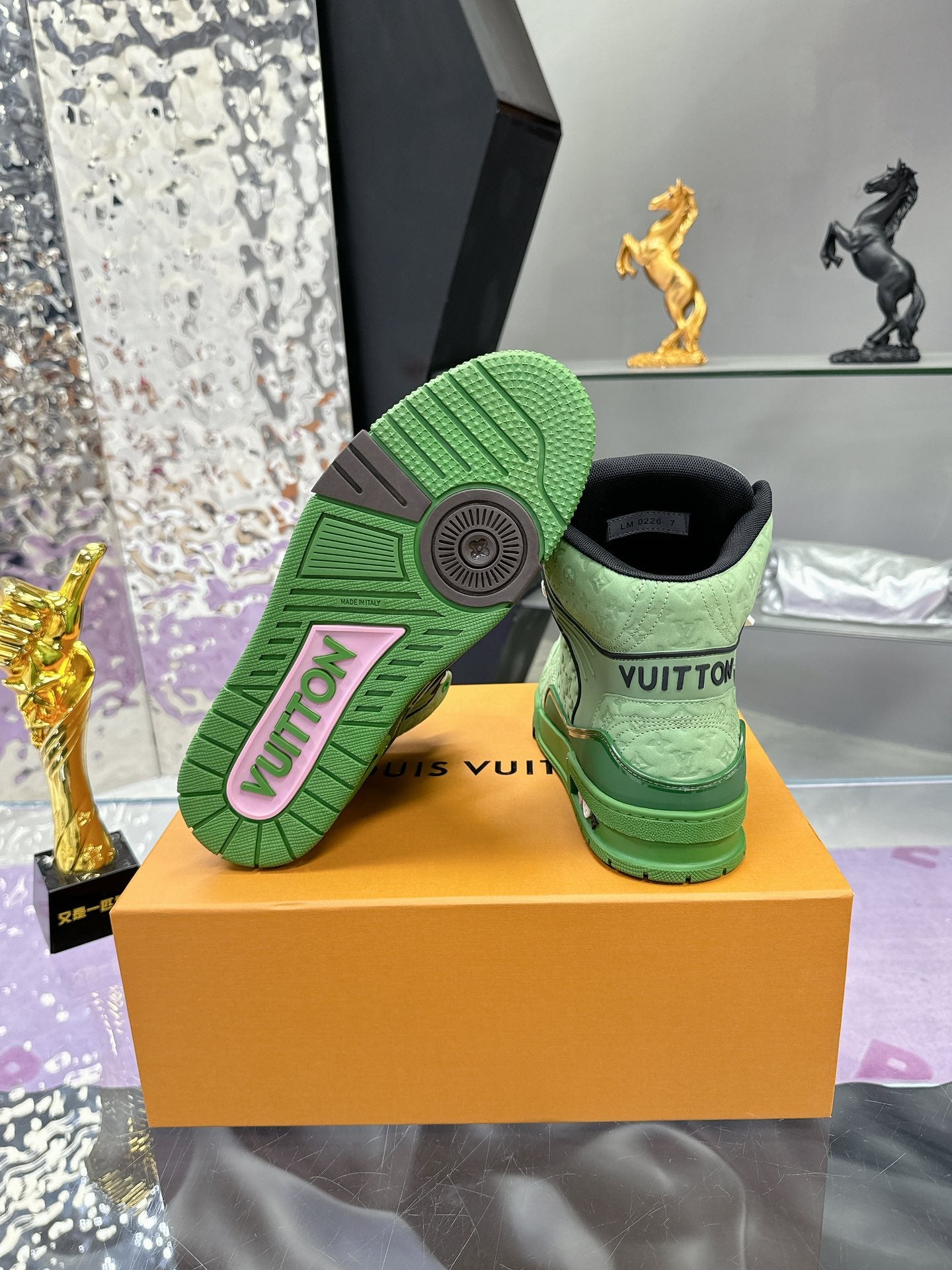 Green Louis Vuitton high-top sneaker outsole and heel, showing tread and logo patch