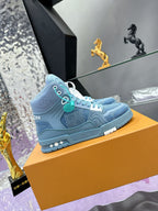 Light blue high-top sneaker with side logo, teal lace accents and textured upper