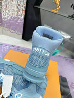 Stacked light blue high-top sneakers showing white logo on heel and front panels