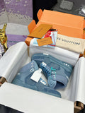 Light blue high-top sneakers in box with white and teal lace details, side logo patches