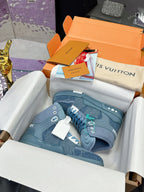Light blue high-top sneakers in box with white and teal lace details, side logo patches