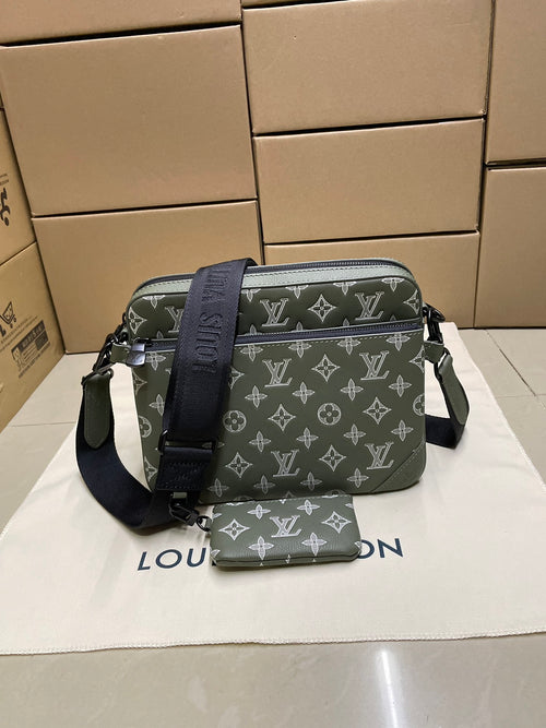 Green monogram crossbody bag with front zipper and adjustable shoulder strap