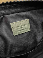 Black fabric interior with stitched logo patch reading Louis Vuitton Paris