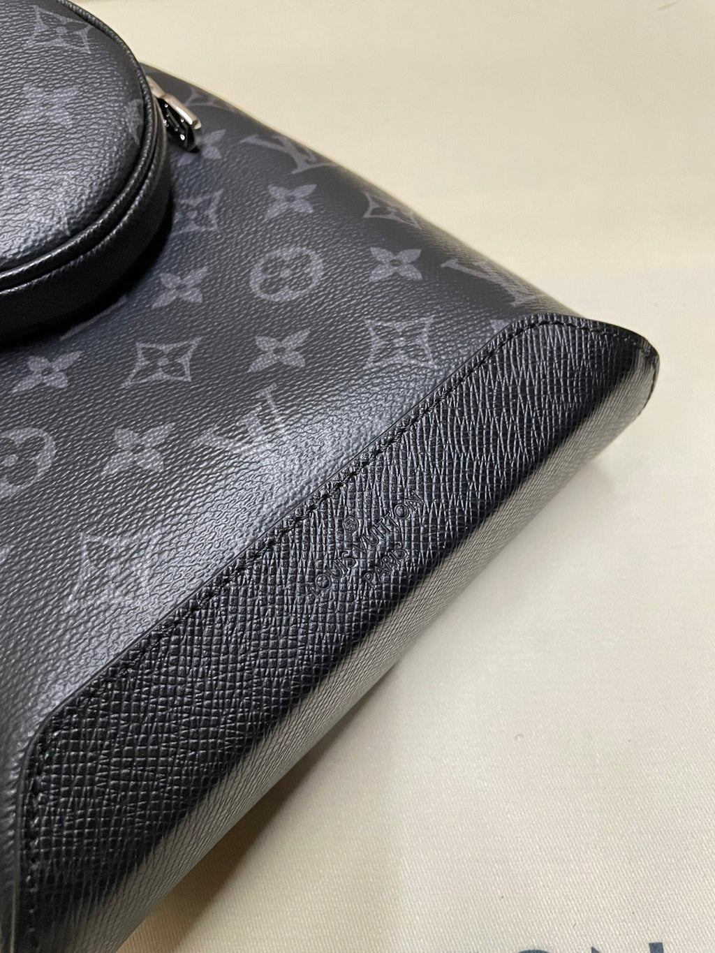 Textured monogram bag trim with grained leather edge
