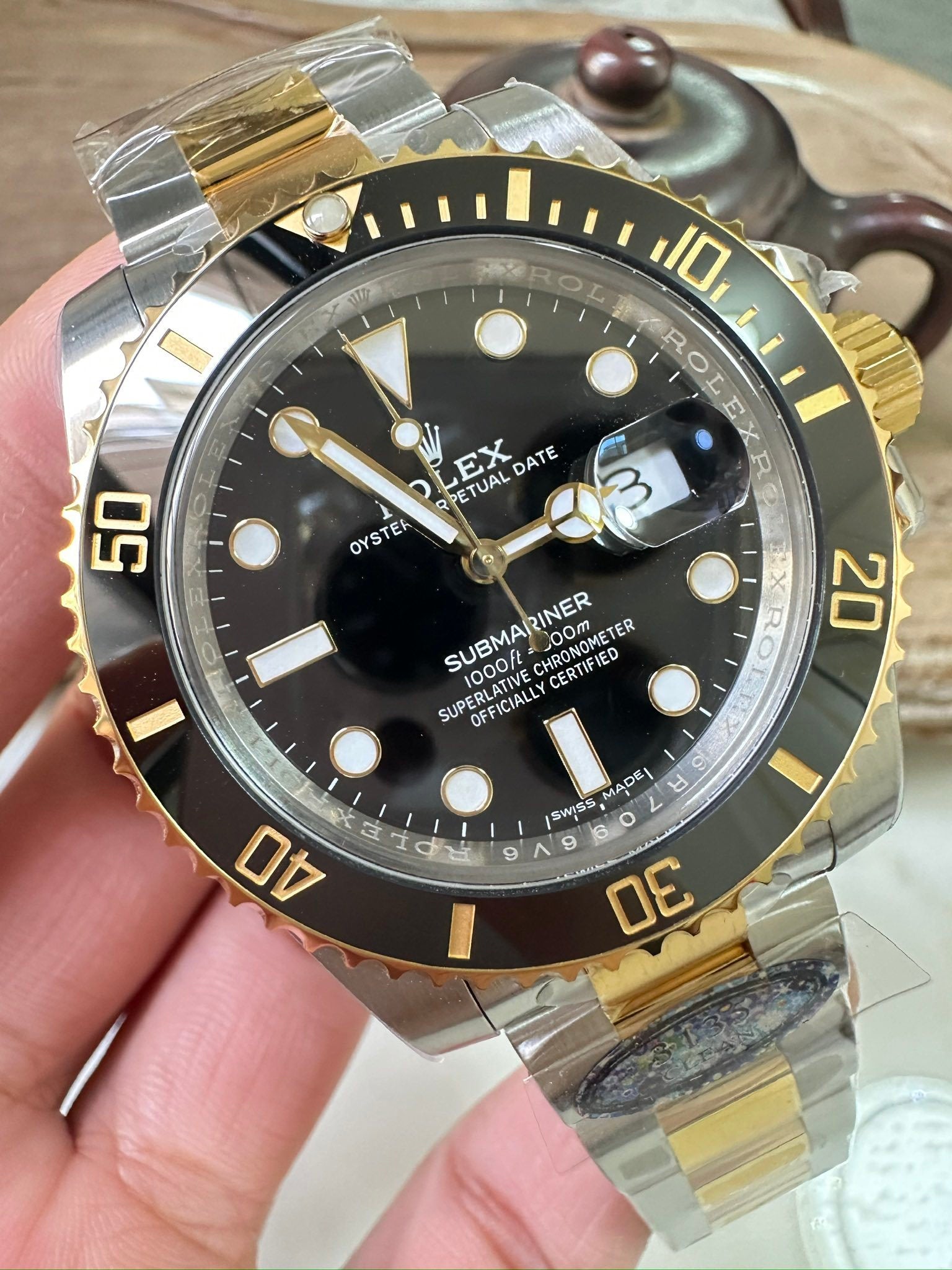 Rolex Submariner wristwatch, black dial with gold bezel on two-tone metal bracelet