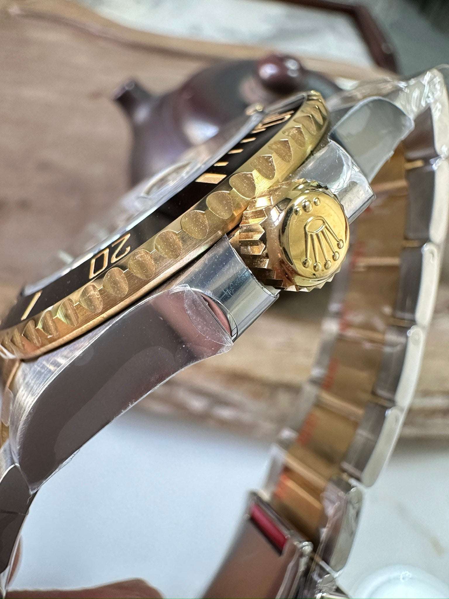Rolex Submariner side of watch with gold accents and two-tone metal bracelet