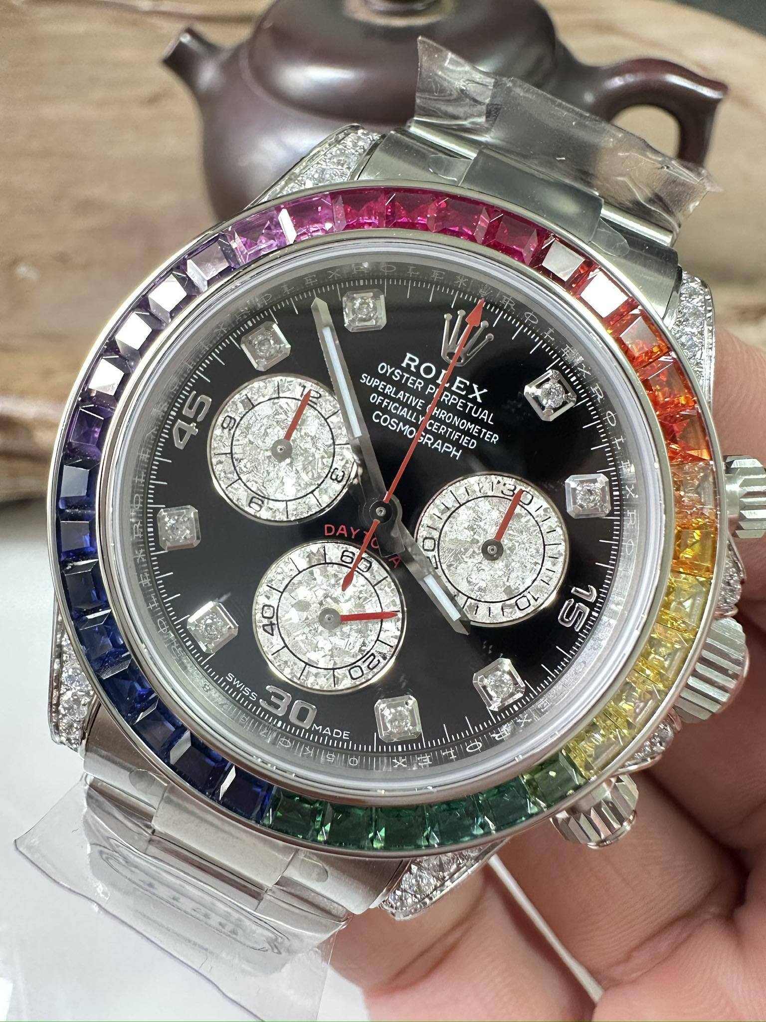 Rolex Daytona watch with black dial, three subdials, jeweled bezel, steel bracelet
