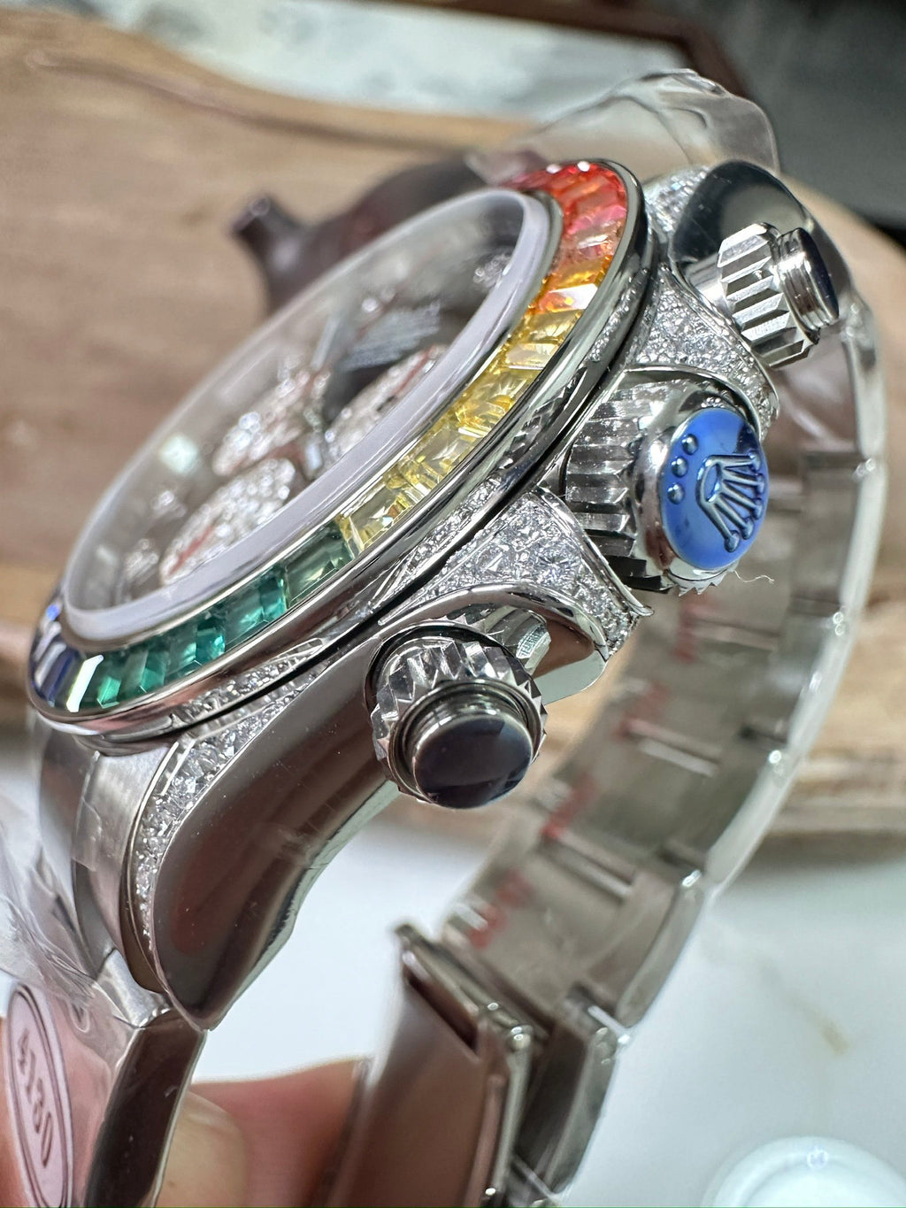 Rolex Daytona watch side with crown and pushers, crystal-studded case, stainless bracelet