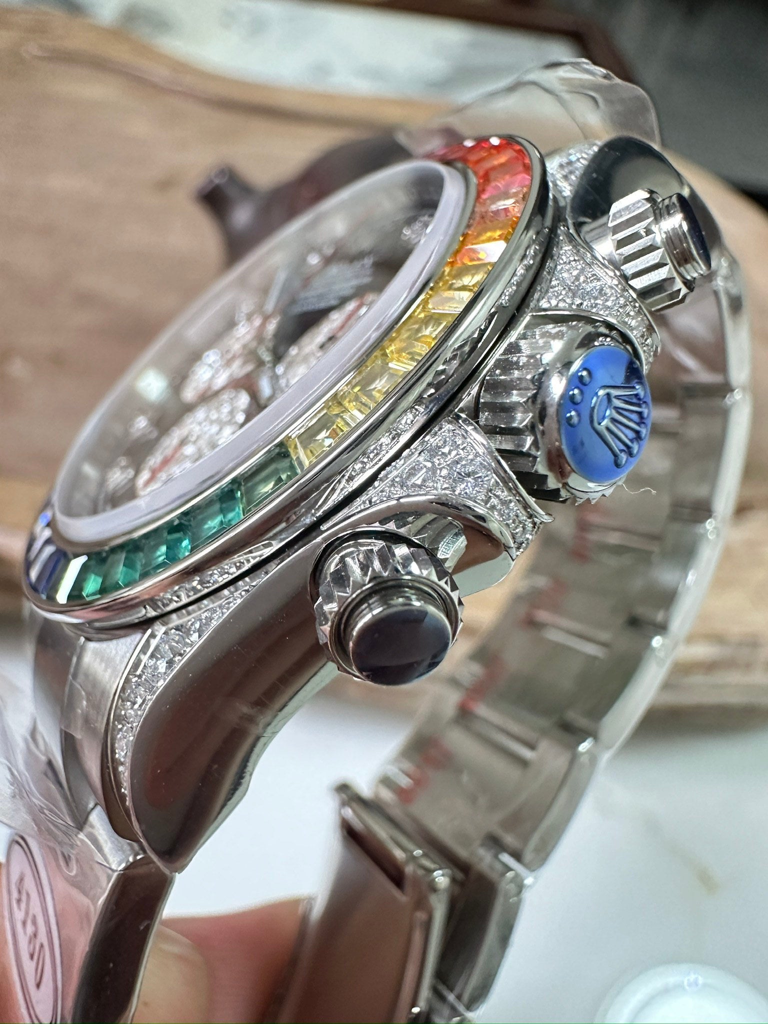 Rolex Daytona watch side with crown and pushers, crystal-studded case, stainless bracelet
