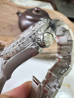 Rolex watch side profile with stainless steel bracelet and crown detail