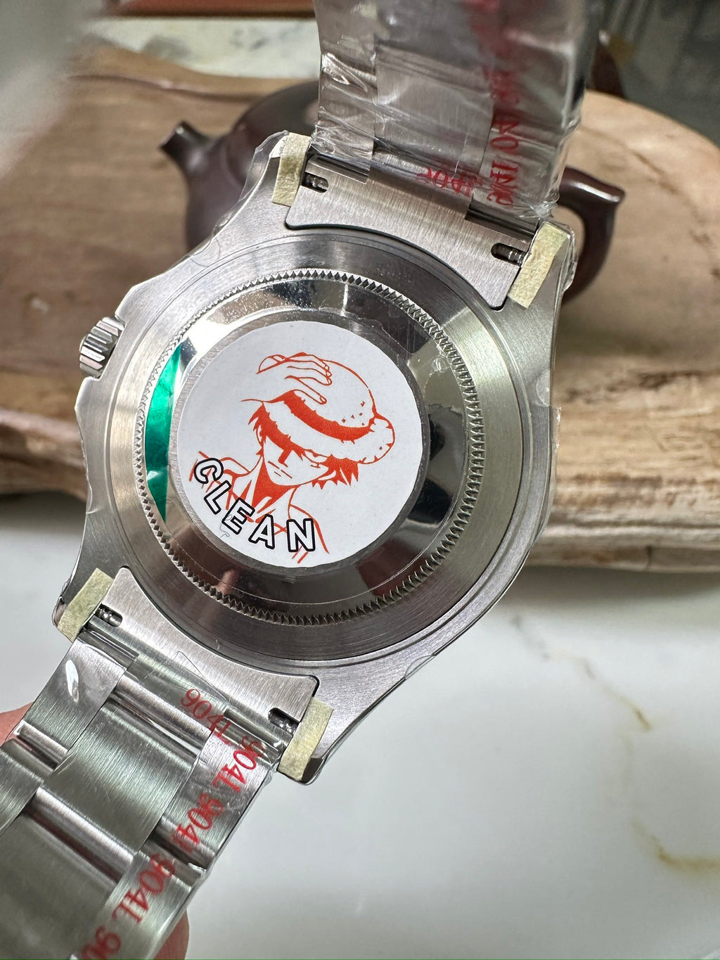 Rolex watch caseback with stainless steel and CLEAN logo sticker