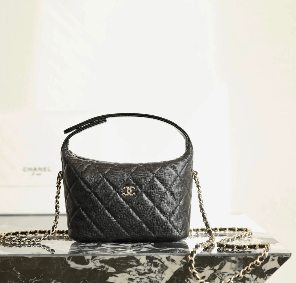 Black quilted Chanel mini handbag with CC logo and gold chain strap