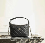 Black quilted Chanel mini handbag with CC logo and gold chain strap