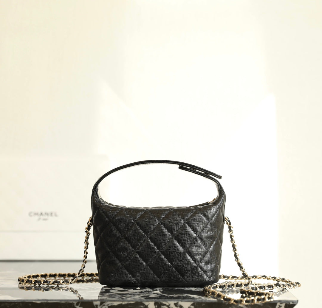 Black quilted Chanel mini handbag with rounded top and gold chain strap