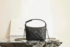Black quilted Chanel mini handbag, top handle and gold chain strap