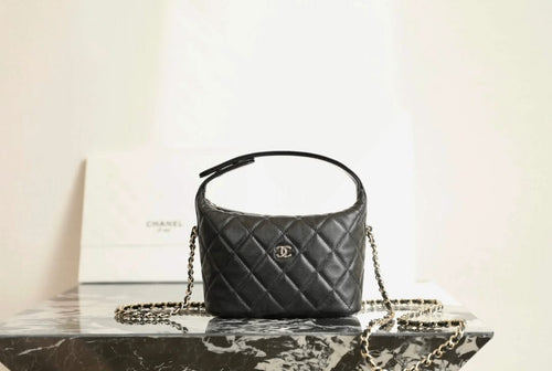 Black quilted Chanel mini handbag, top handle and gold chain strap