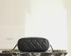 Black quilted Chanel mini handbag side view with chain strap