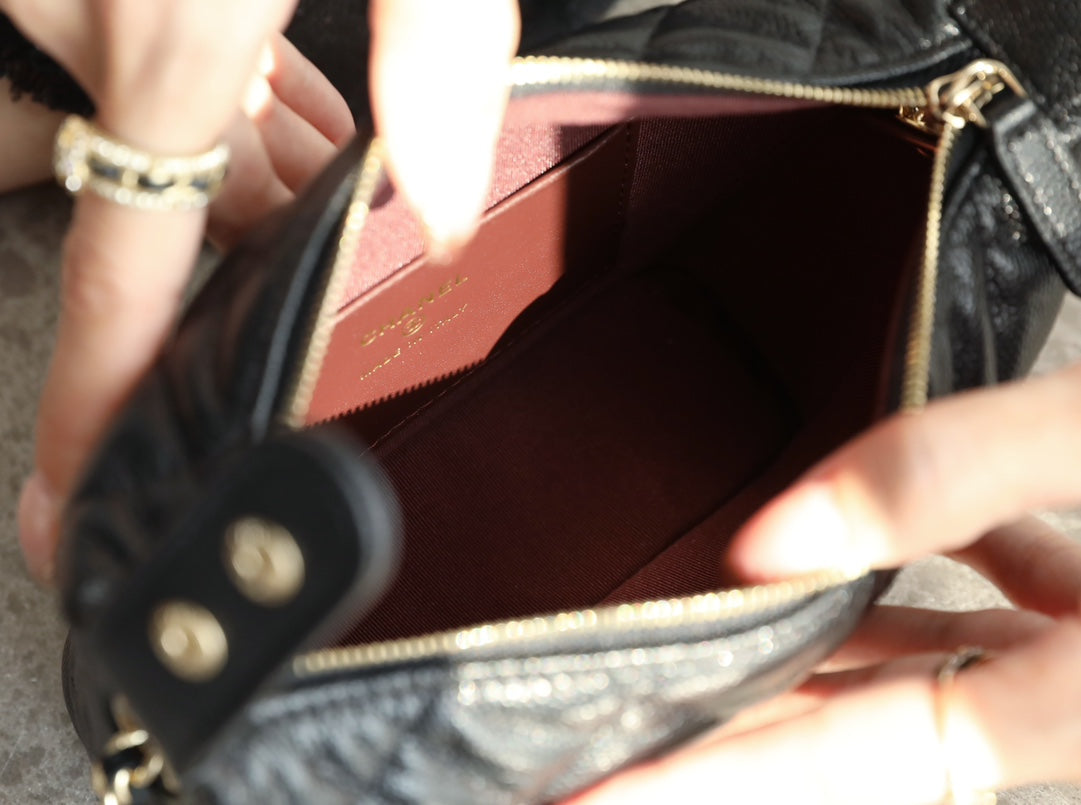 Open Chanel mini handbag interior with burgundy lining