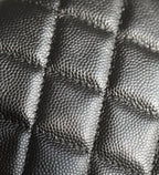 Black quilted leather close-up with diamond stitching texture